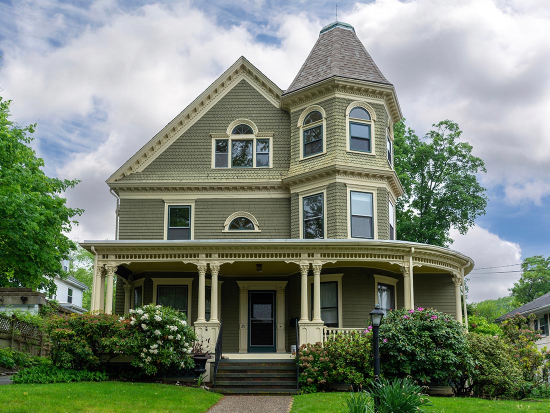 Olive green Queen Anne Victorian with wraparound porch and turret, Northeast Florida