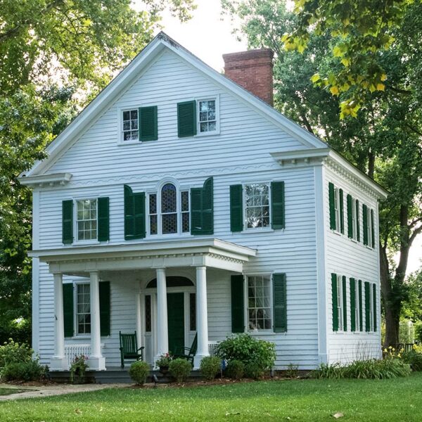 White Colonial home with green shutters and columned porch in Northeast Florida White Colonial home with green shutters and columned porch in Northeast Florida