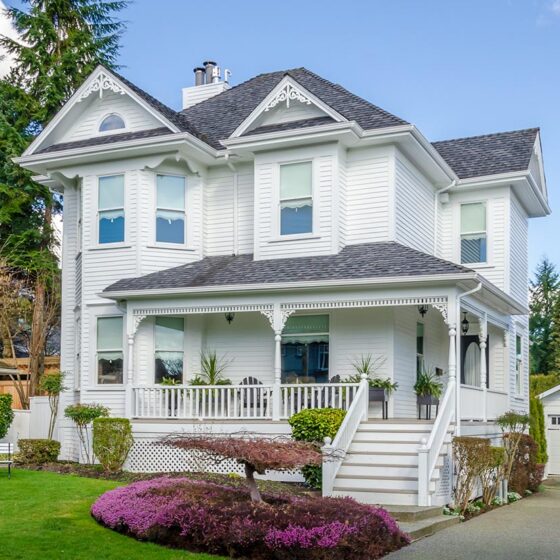 White Victorian home with wraparound porch and gable ornamentation in Northeast Florida