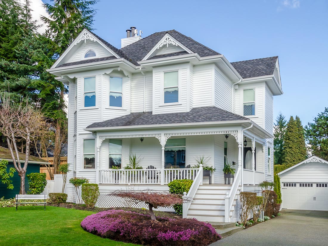 White Victorian home with wraparound porch and gable ornamentation in Northeast Florida