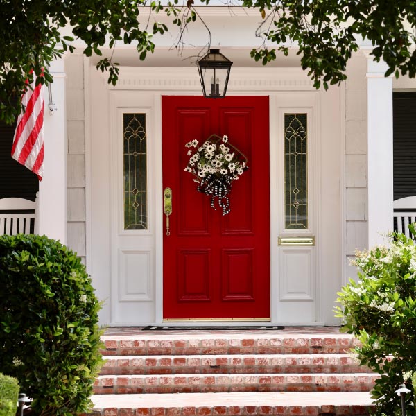 Historic home exterior restoration featuring red front door and brick steps, M&M Homes, Jacksonville