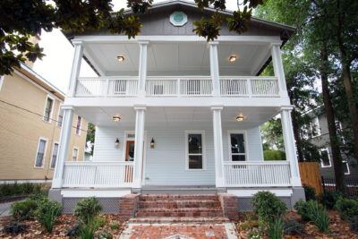 Two story colonial home in Historic Springfield with stacked front porches and brick entry steps