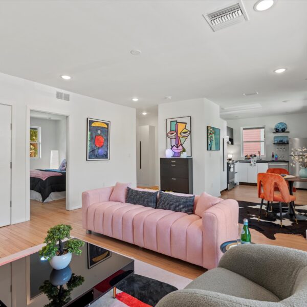 010b-spacious-unit-living-room-remodel Luminous living room layout highlighting high-end flooring installed during an apartment remodel.