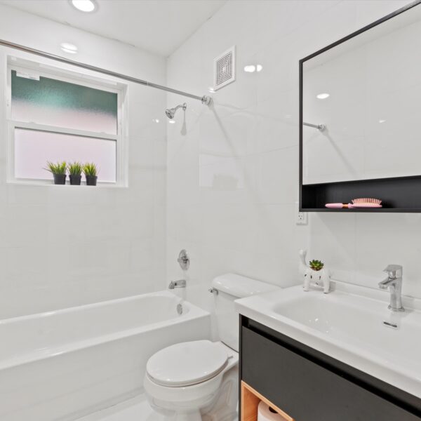 018-apartment-guest-bathroom-remodel Sleek multi-unit residential bathroom restoration with durable tile and premium updates.