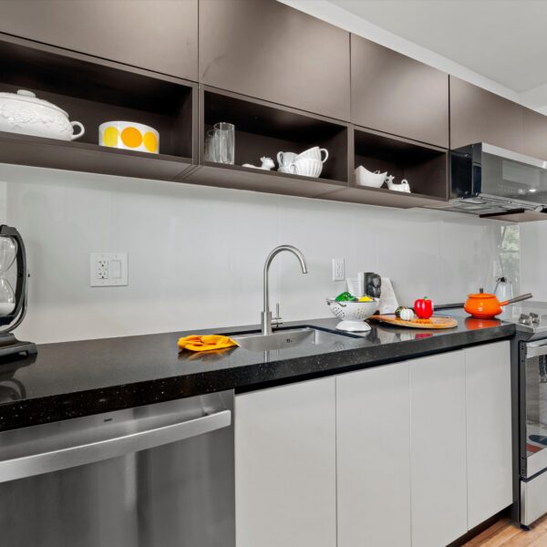 035-luxury-apartment-kitchen-remodel Bright apartment kitchen renovation with new flooring and functional modern appliances.