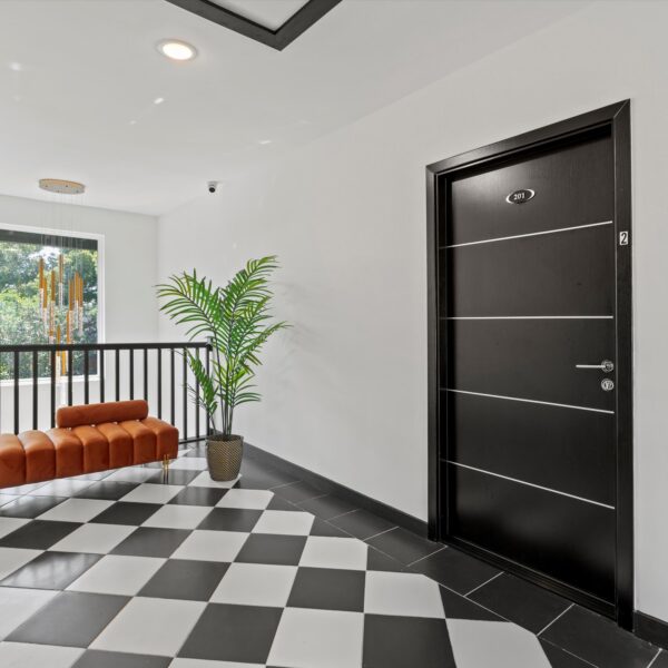 07b-updated-residential-building-hallway Clean contemporary hallway layout featuring durable finishes for a multi-family renovation.