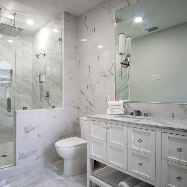 12-classic-colonial-bathroom-glass-shower-marble-tile Glass enclosed shower with a mosaic floor sits beside the double vanity in this bathroom