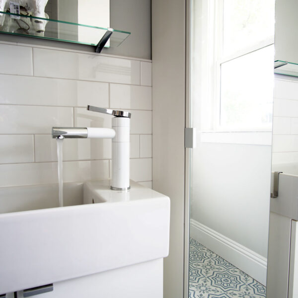 14-classic-colonial-bathroom-sinks-subway-tile White subway tile and twin wall mounted sinks in a bathroom with patterned floor tile