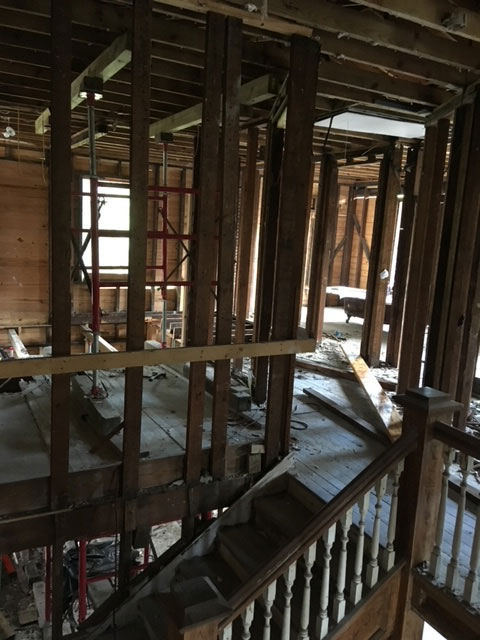 classic-colonial-during-open-framing-shored-interior-jacksonville-mnm-homes-04-07 Structural work in progress: interior open to bare framing with temporary shoring posts and braces