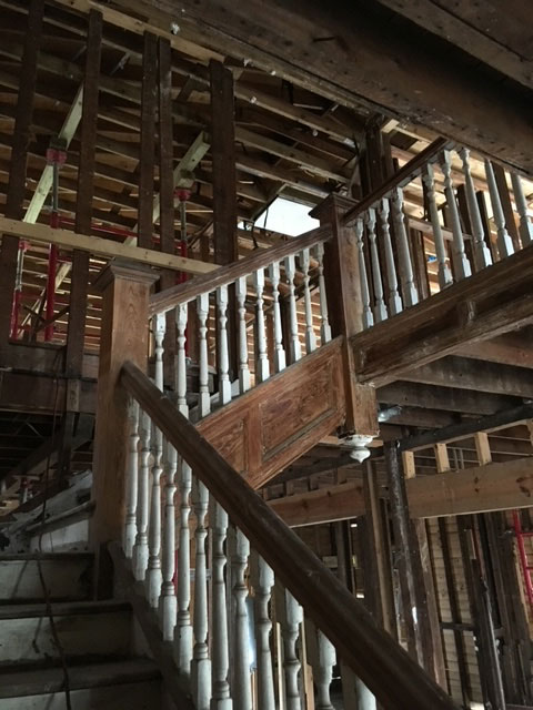 classic-colonial-during-original-staircase-stripped-walls-jacksonville-mnm-homes-04-06 Work in progress: original turned staircase standing amid walls stripped to bare studs and framing