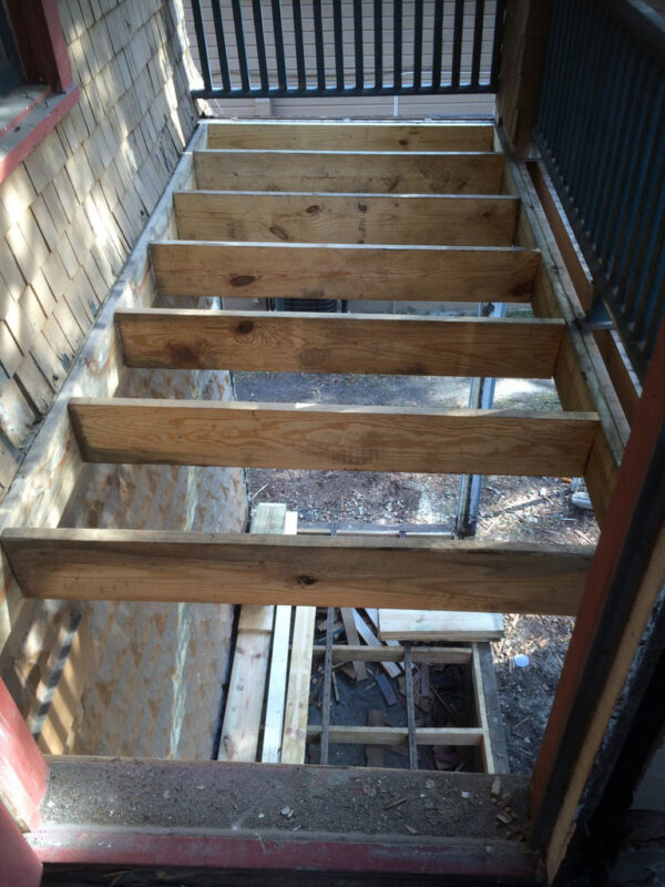 fireplace-house-during-new-porch-floor-joists-jacksonville-mnm-homes-01-04 Work in progress: porch with the original decking removed and new floor joists set in place