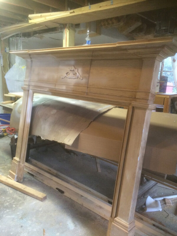 fireplace-house-during-stripped-original-mantel-millwork-jacksonville-mnm-homes-01-09 Work in progress: original carved wood mantel stripped of finish and set up in a work area
