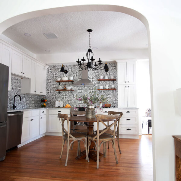 modern-farmhouse-arched-kitchen-doorway-jacksonville-mnm-homes-04 View through the arched doorway into the kitchen with open wood shelves and rich hardwood flooring