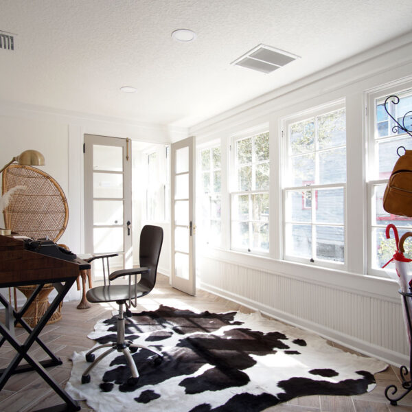 modern-farmhouse-beadboard-room-jacksonville-mnm-homes-15 Light filled room lined with windows and beadboard wainscot above a herringbone tile floor