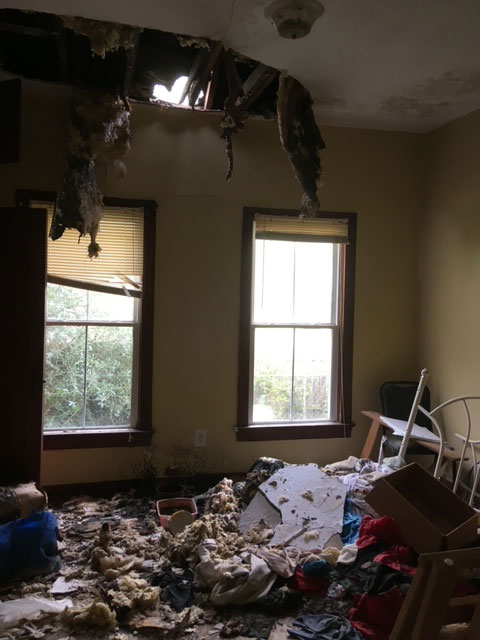 modern-farmhouse-before-collapsed-ceiling-roof-opening-jacksonville-mnm-homes-07-03 Before renovation: a collapsed ceiling open to daylight above a floor covered in debris and insulation