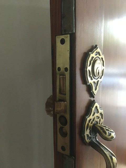 modern-farmhouse-during-brass-door-hardware-detail-jacksonville-mnm-homes-07-09 Renovation in progress: ornate brass handle and mortise lock plate fitted on a wood door edge