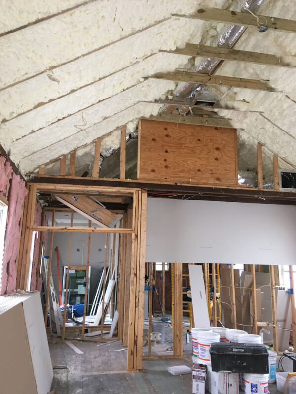 shotgun-house-before-walls-opened-to-framing-jacksonville-mnm-homes-03-04 Before renovation: interior walls opened to bare framing under a newly insulated roof slope