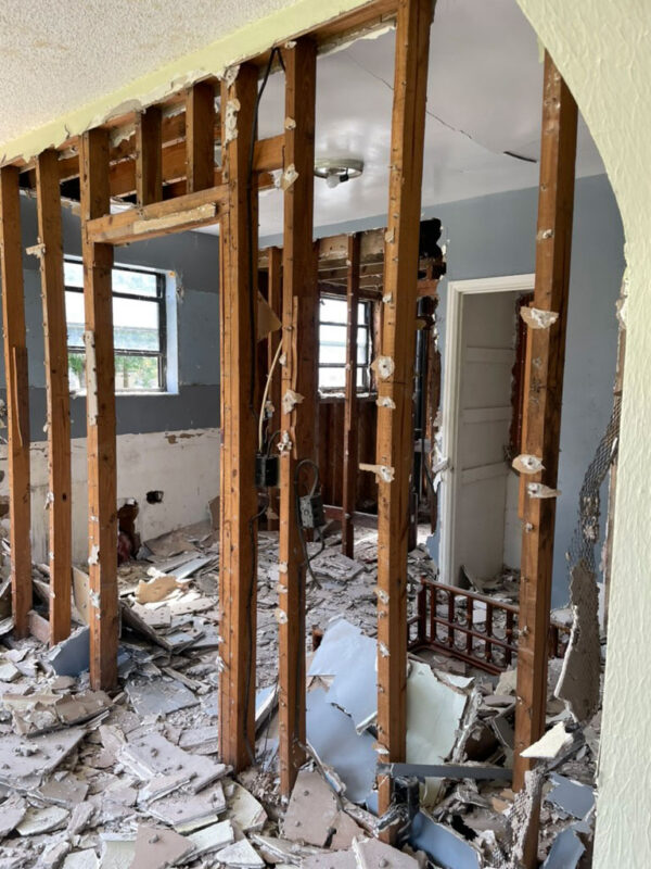 zen-garden-during-exposed-stud-partition-walls-jacksonville-mnm-homes-05-10 Work in progress: interior partitions stripped to bare studs with plaster debris covering the floor